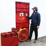 Technician setting up a Retrotec 6100 series blower door